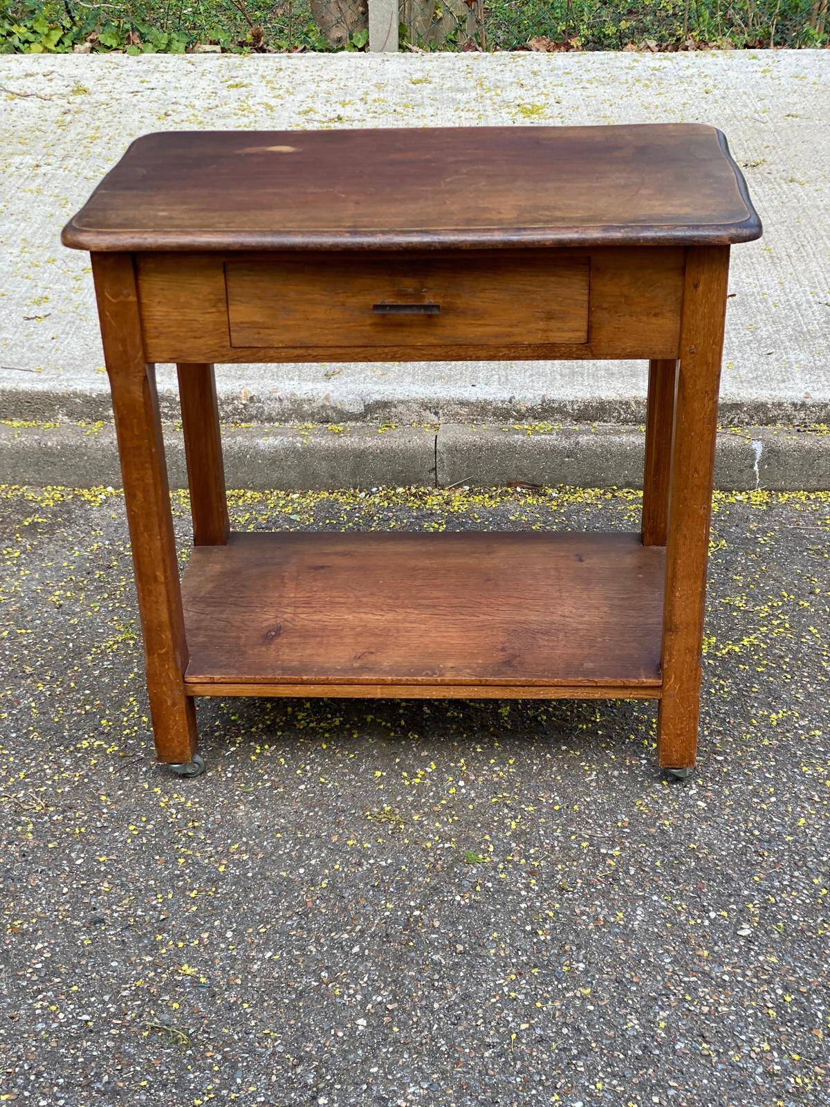 Vintage farmhouse dessert trolley on wheels made of solid wood from the 19th century.