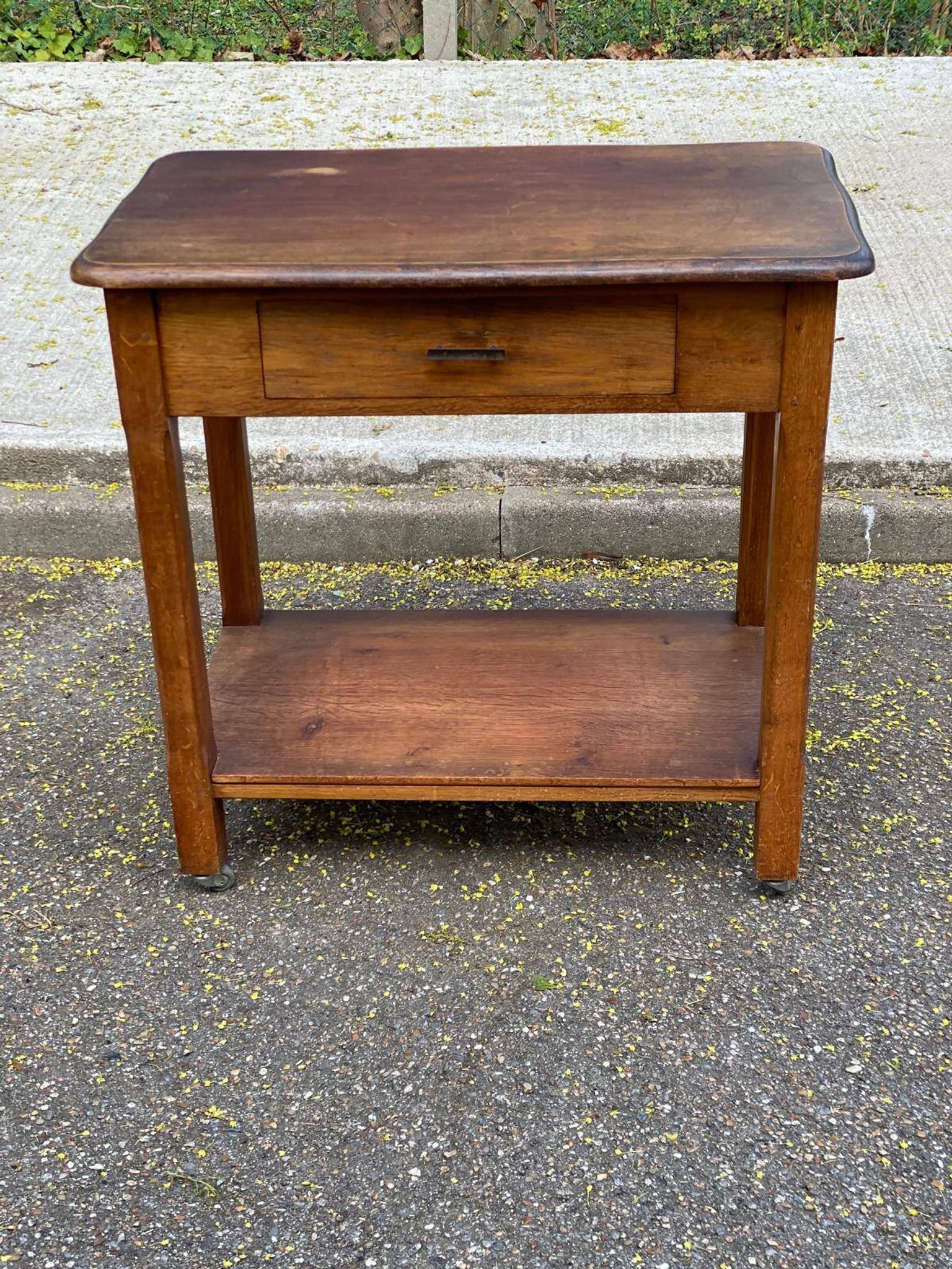 Vintage farmhouse dessert trolley on wheels made of solid wood from the 19th century.