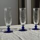 Set of 6 blue-footed champagne flutes; 3 pairs of designs.