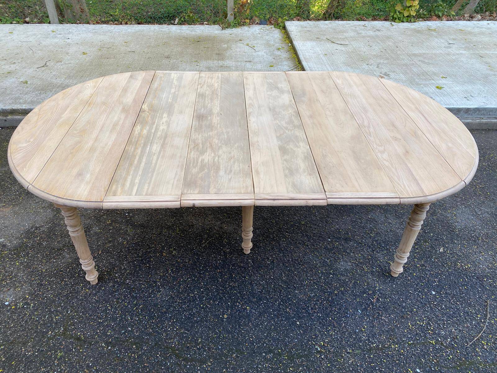 Renovated Louis Philippe round extendable dining table with 4 leaves.