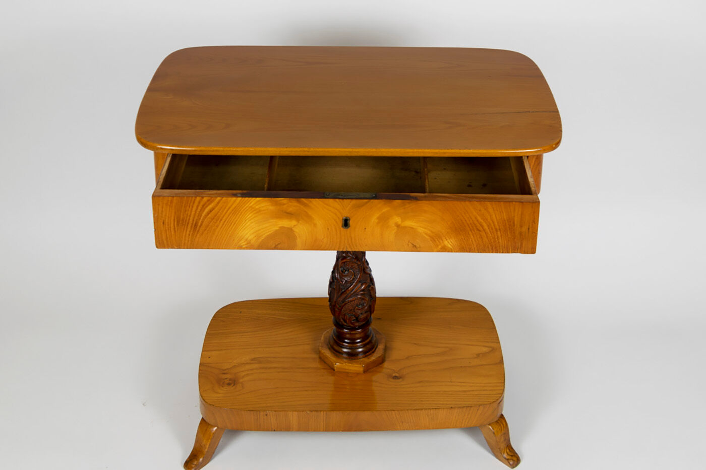 Danish Biedermeier elm occasional table with carved base and drawer