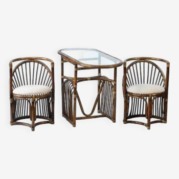 Bamboo garden table with a glass top and two armchairs.