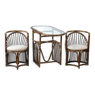 Bamboo garden table with a glass top and two armchairs.