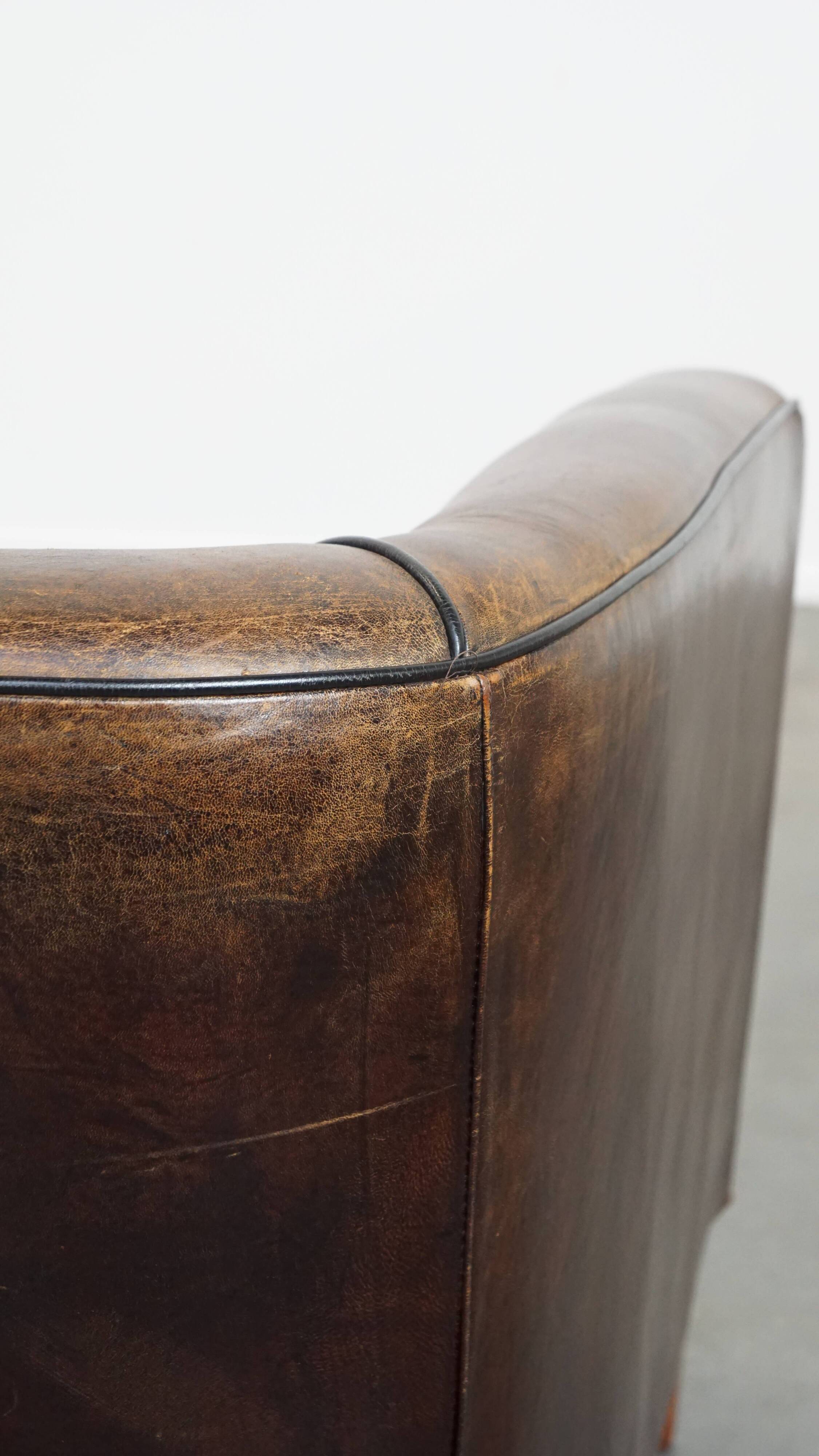 Sheep leather club chair finished with black piping