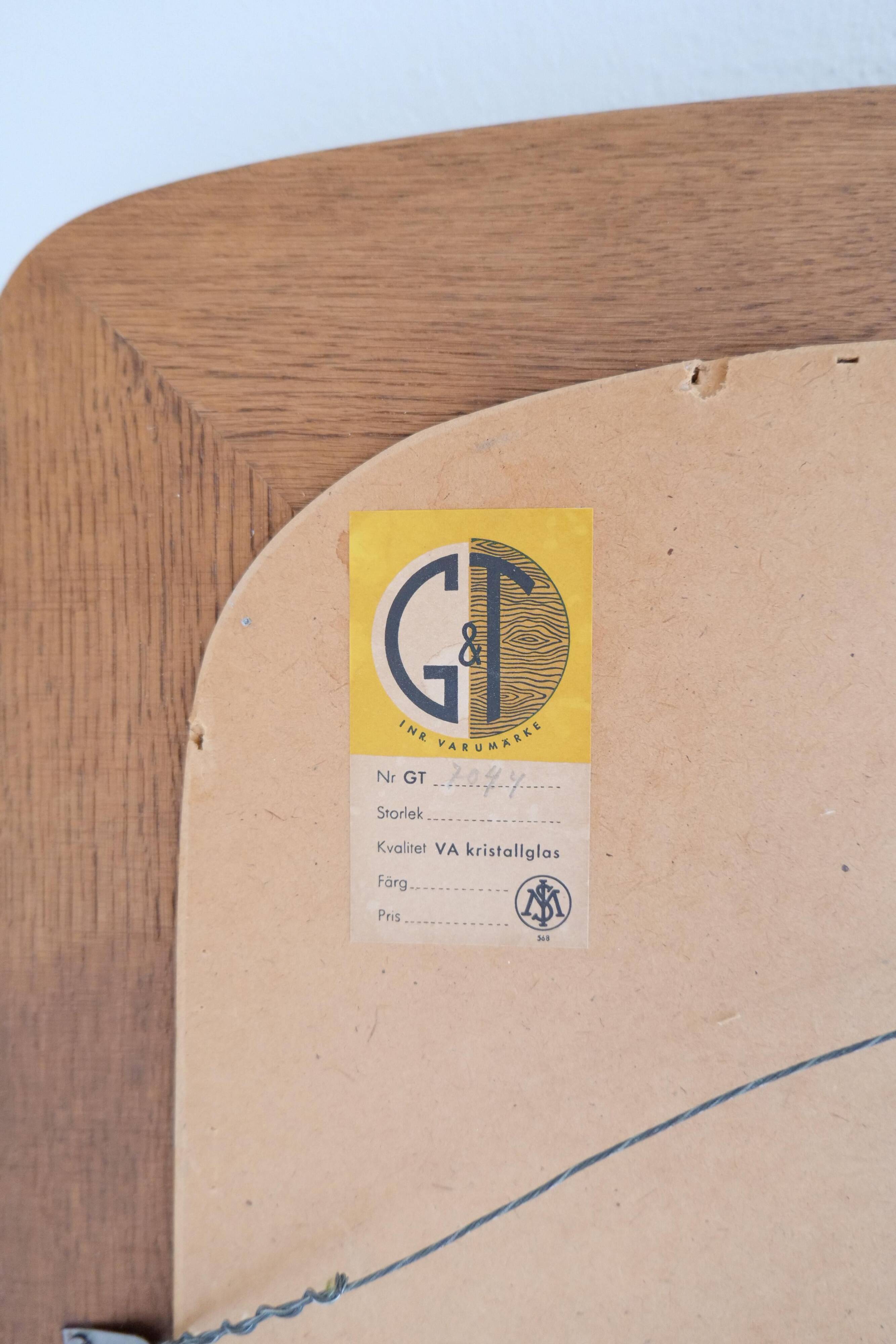 Mid-century modern sculptural wall mirror in stained oak, glass, Glas & Trä 1959