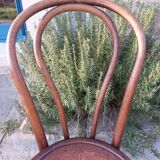 pair of round wooden chairs with a pattern on the seat