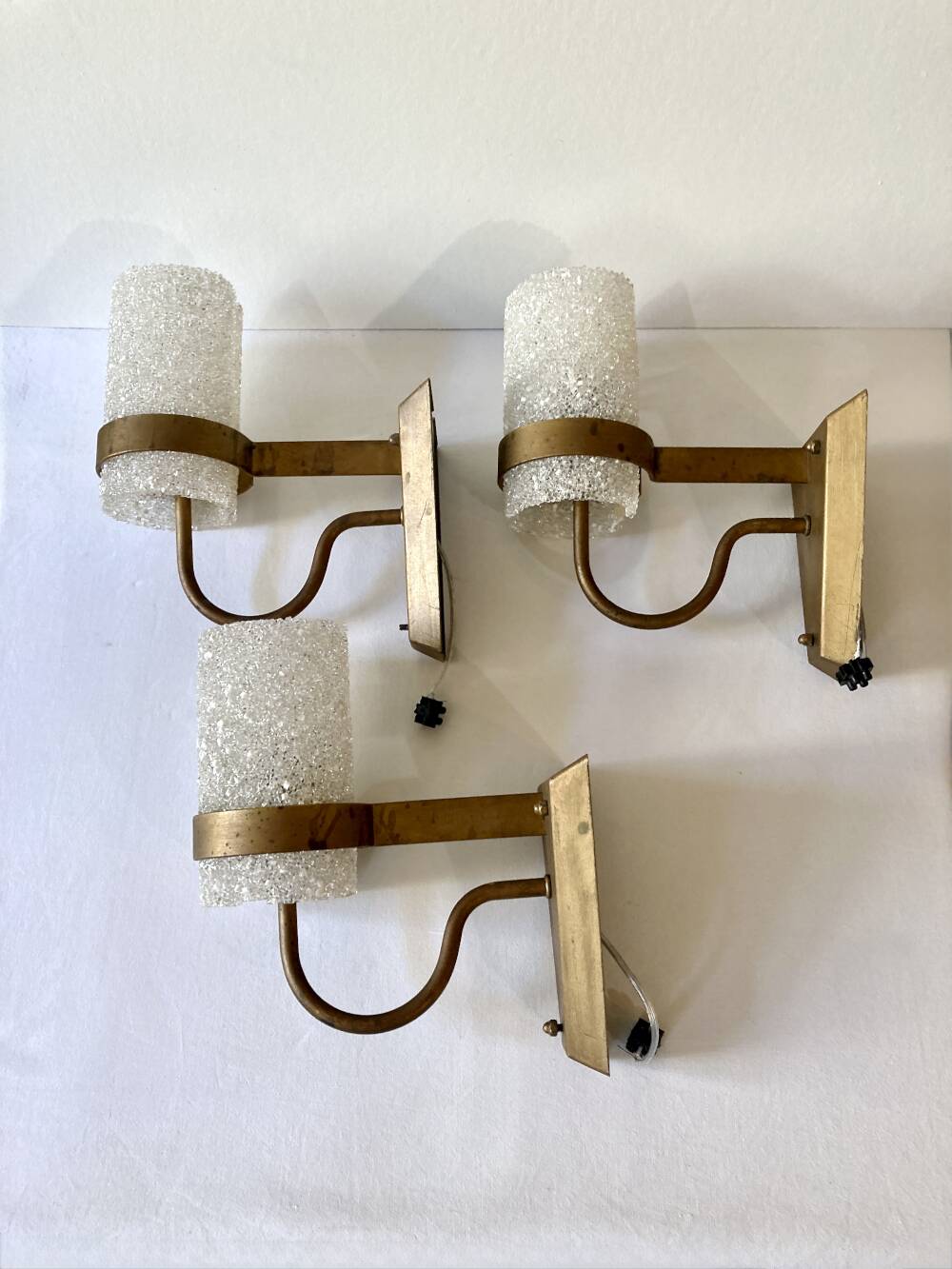 Set of three wall sconces in gold metal and ice effect Perspex, 1960-70.