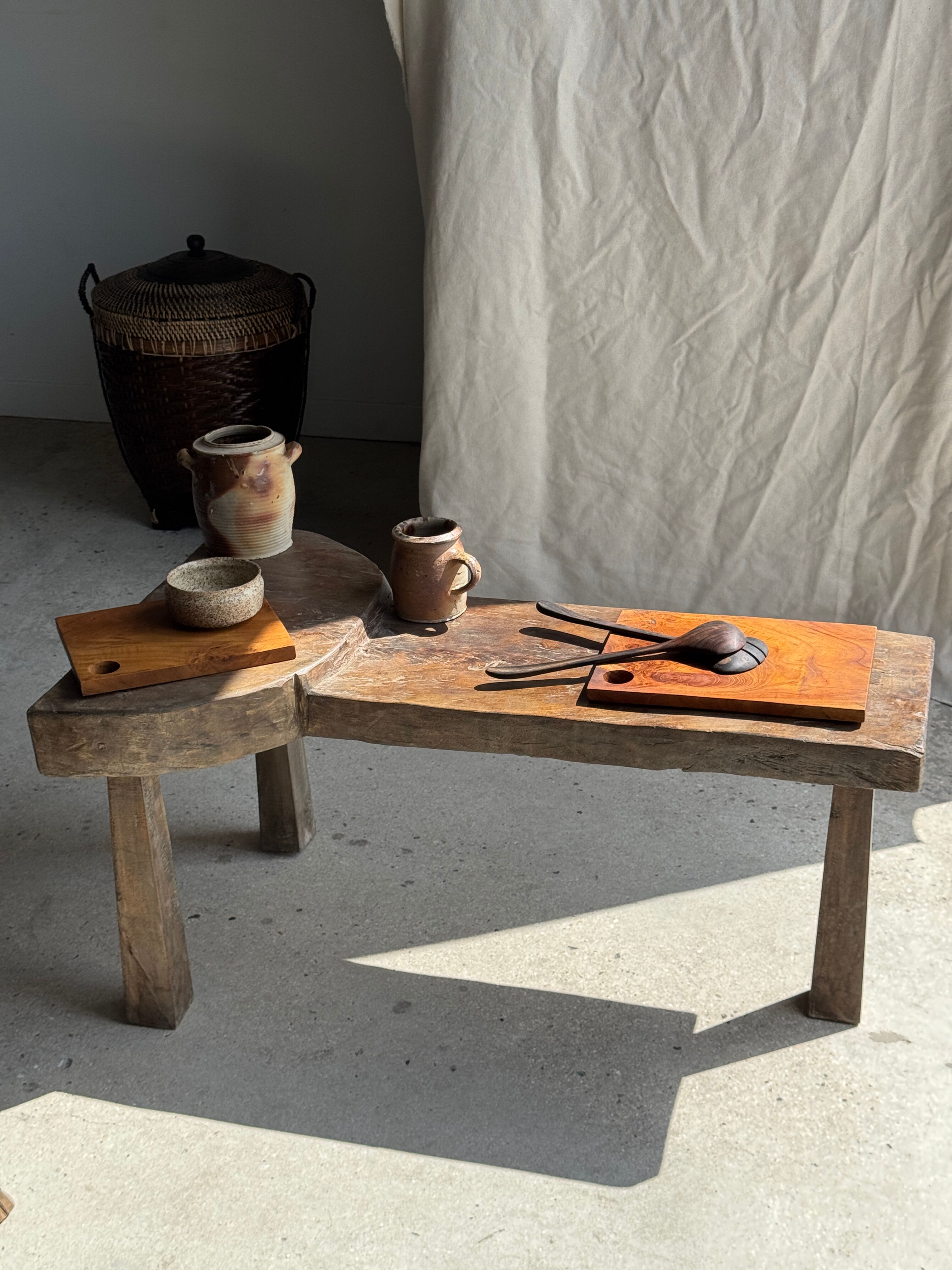Small rectangular teak monoxyle cutting board with a circular handle.