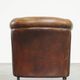 Neat, elegantly finished, cozy sheepskin club armchair with a fixed seat cushion