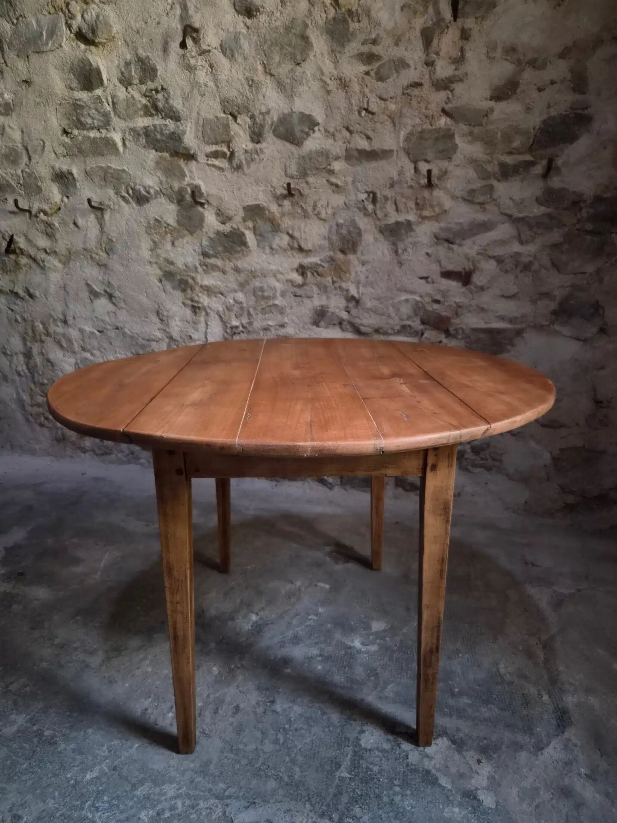 Rustic French antique dining table, drop-leaf table in cherry wood, circa 1900.