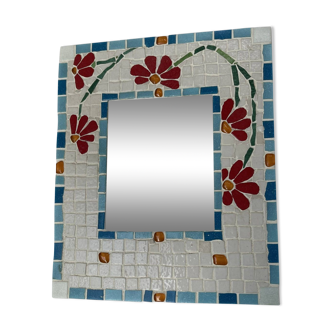 Ceramic mirror with floral decoration.