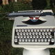 Baby hermes typewriter with manual job and his bag