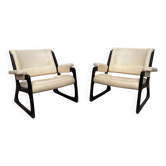 Set of two Baumann sled lounge chairs.