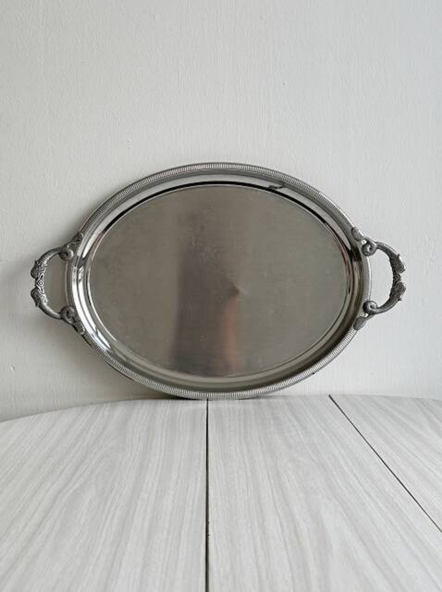 Large stainless steel serving platter with fish-shaped handles.