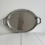 Large stainless steel serving platter with fish-shaped handles.