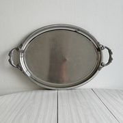 Large stainless steel serving platter with fish-shaped handles.