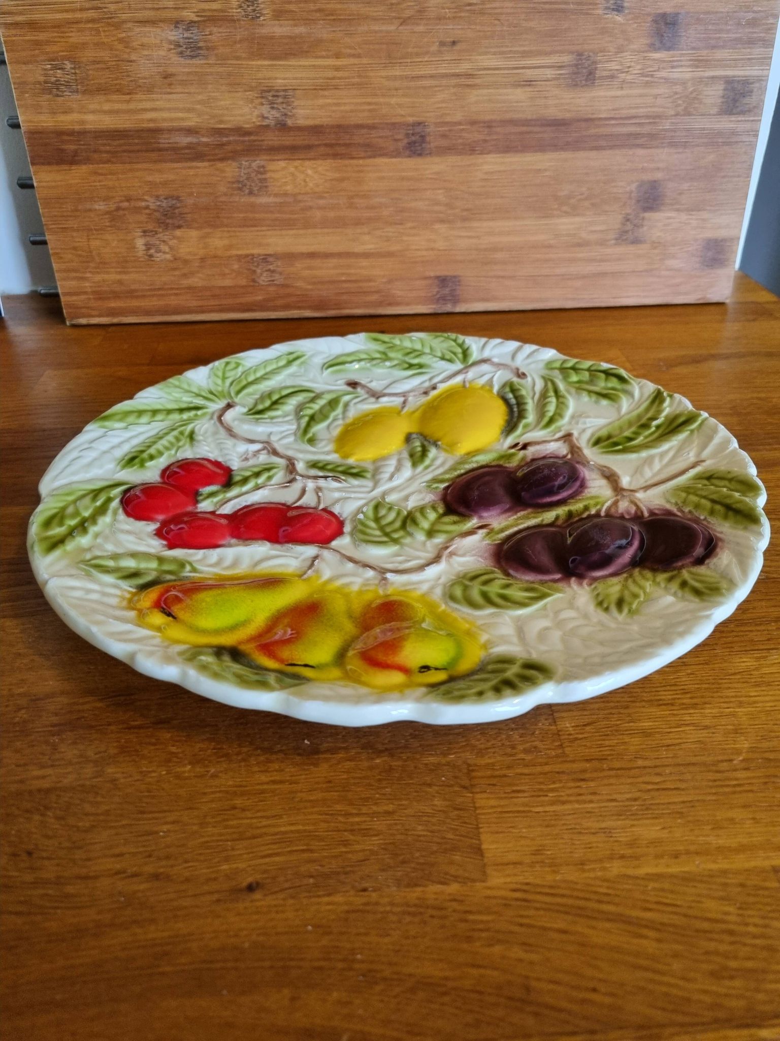 Large vintage earthenware dish with a fruit pattern.