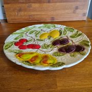 Large vintage earthenware dish with a fruit pattern.