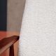 Vintage salon chair in white boucle with a 1950s design.