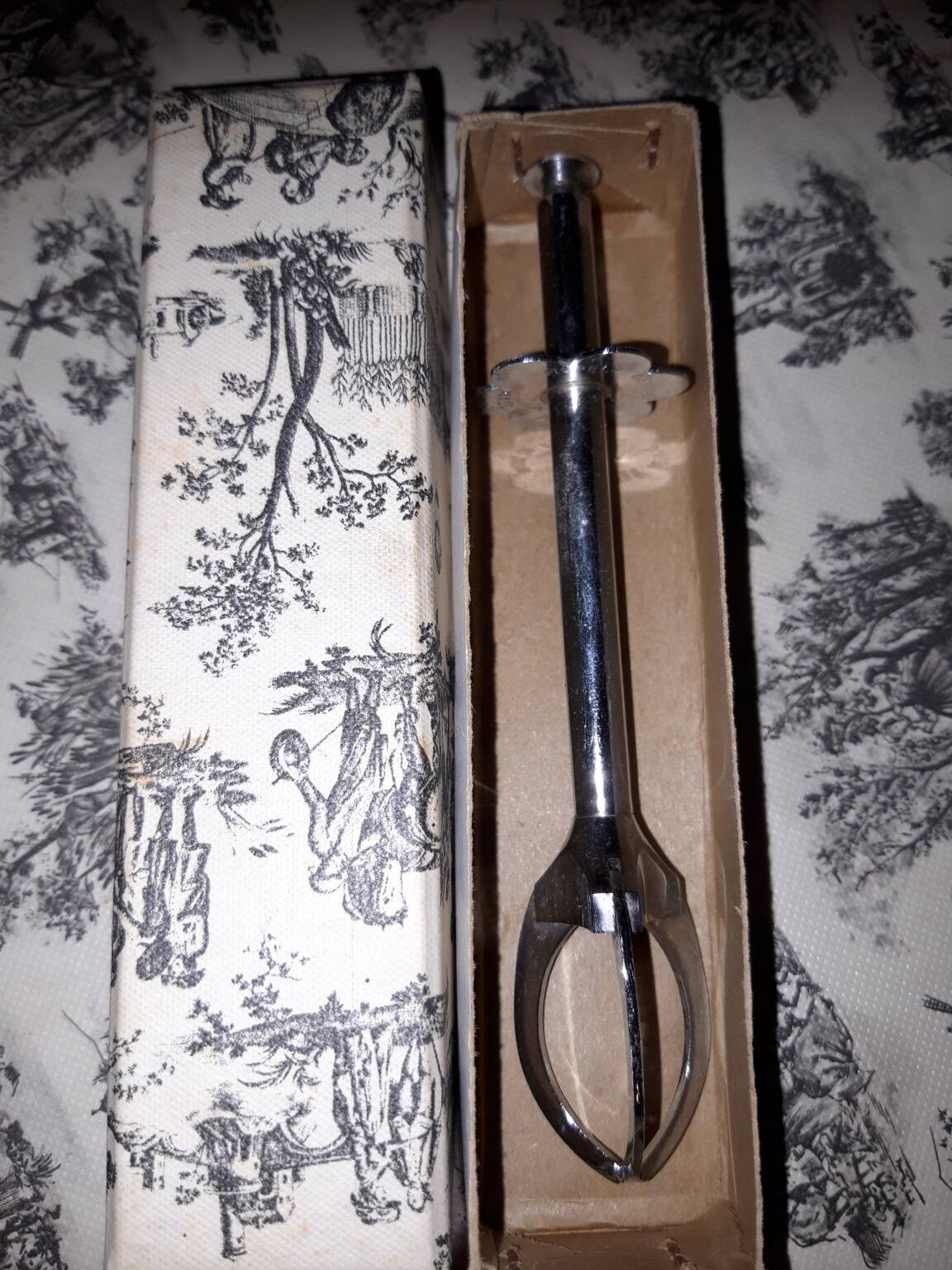 Old sugar tongs with original box.