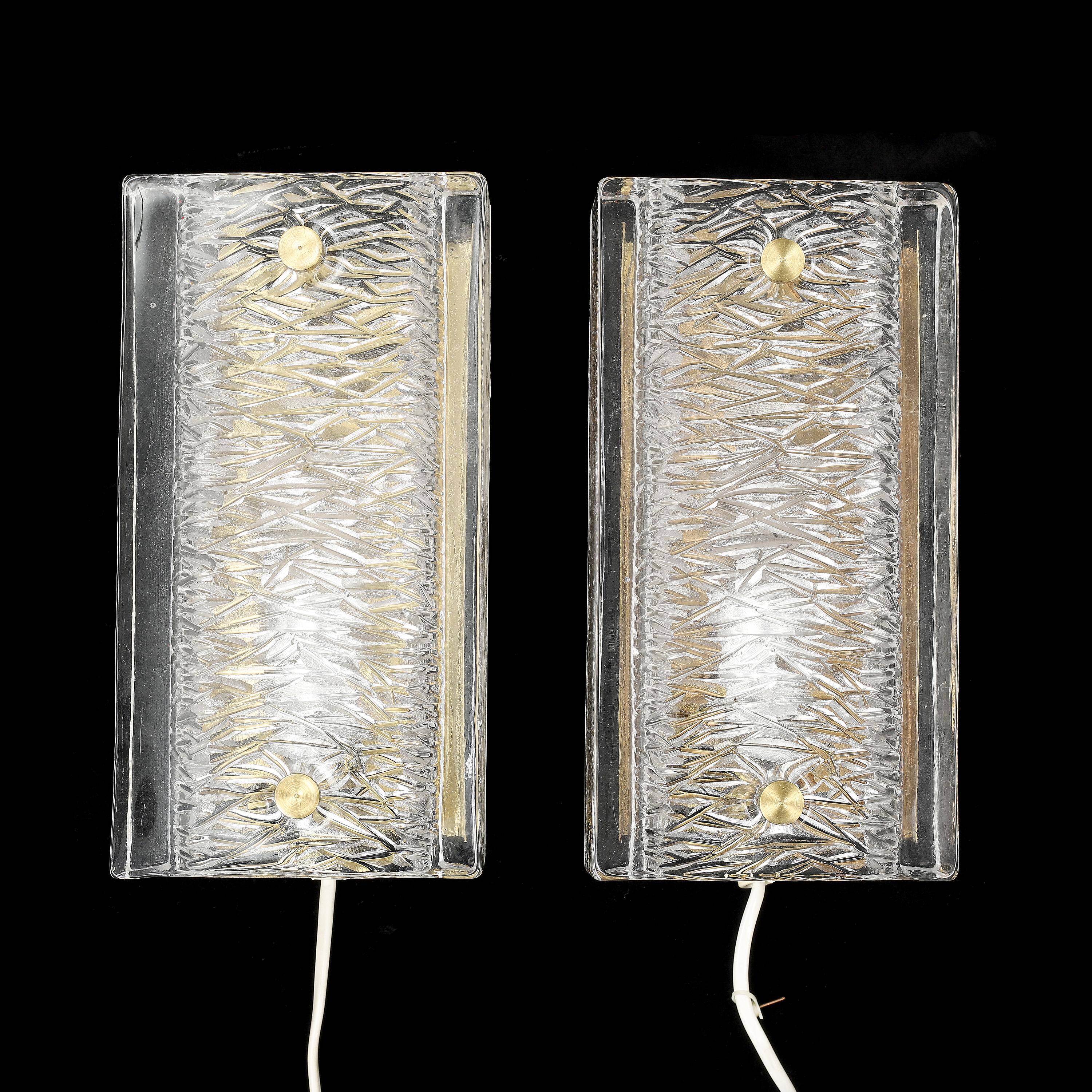 Pair of Orrefors wall lights in cast glass and brass, Sweden 1960.