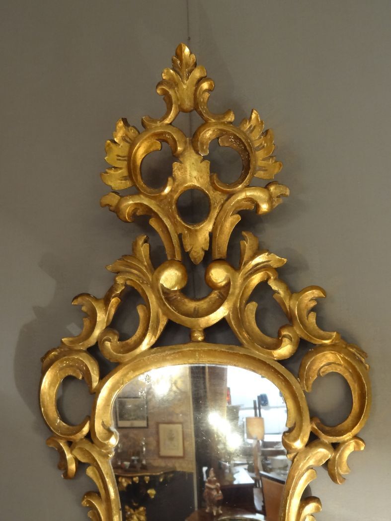 Carved and gilded wooden mirror with gold leaf 46 x 103 cm