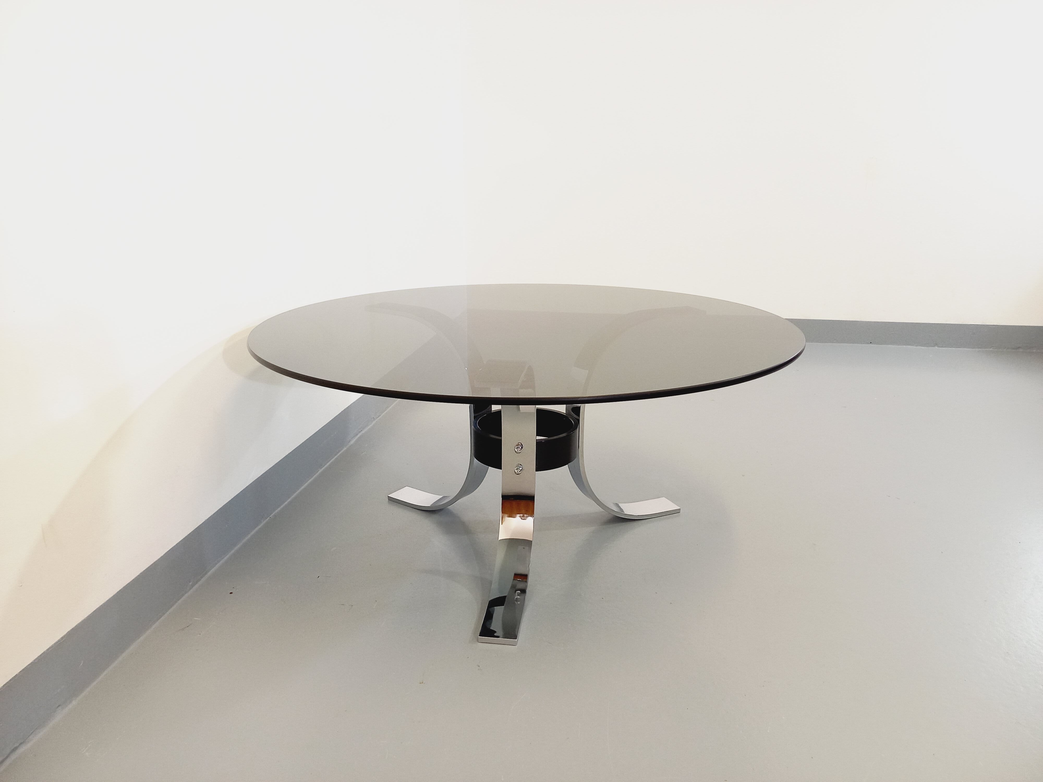 Vintage round coffee table in glass, chromed metal and black metal Space Age style of the 70s