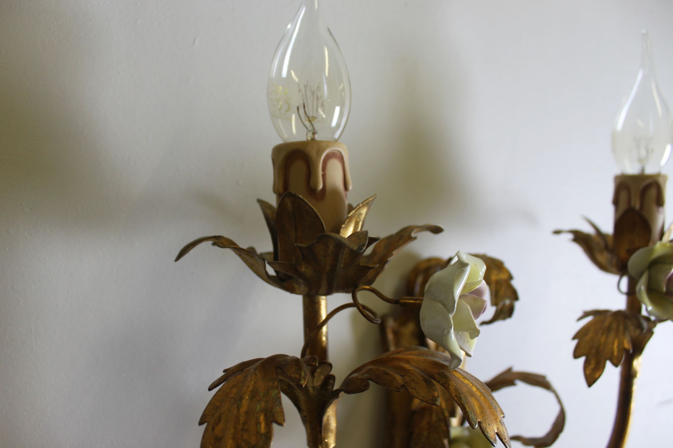 Pair of gold wall sconces with porcelain flowers