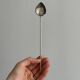 Vintage spoon in old metal, leaf pattern