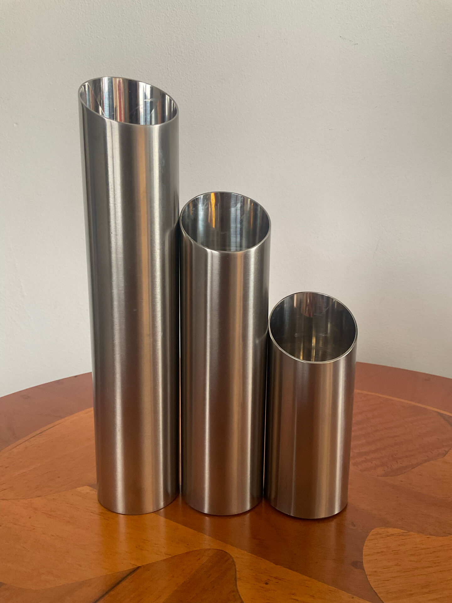 Vintage trio of brushed stainless steel candle holders