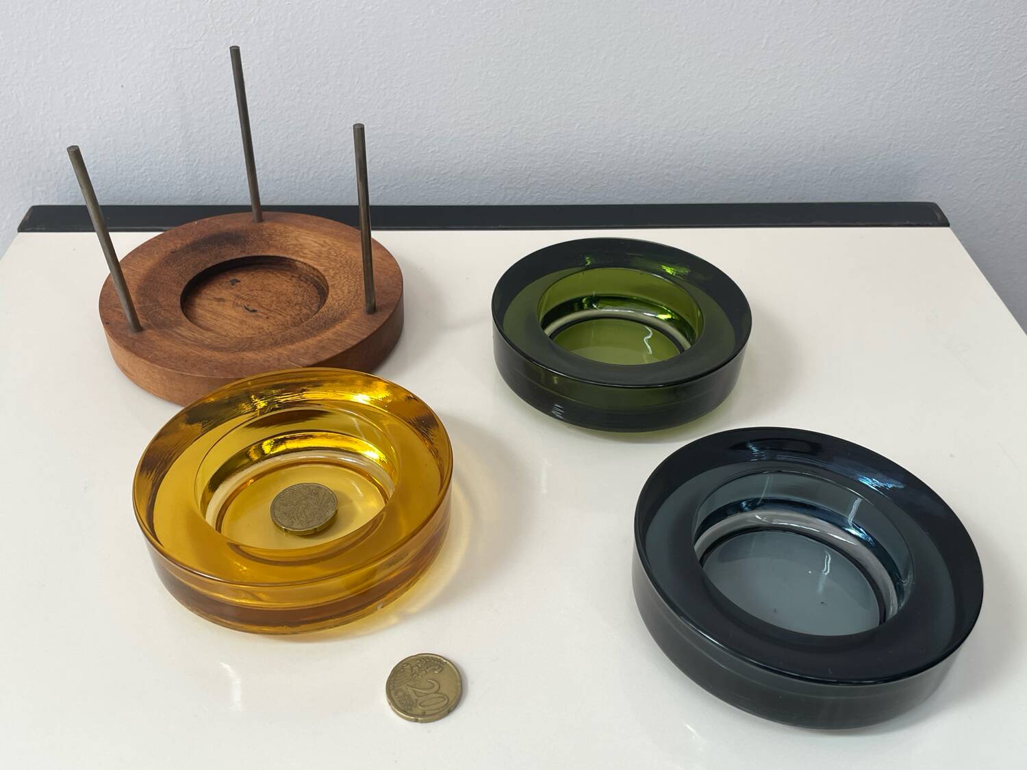 Set of 3 stackable glass catchalls with a teak base.