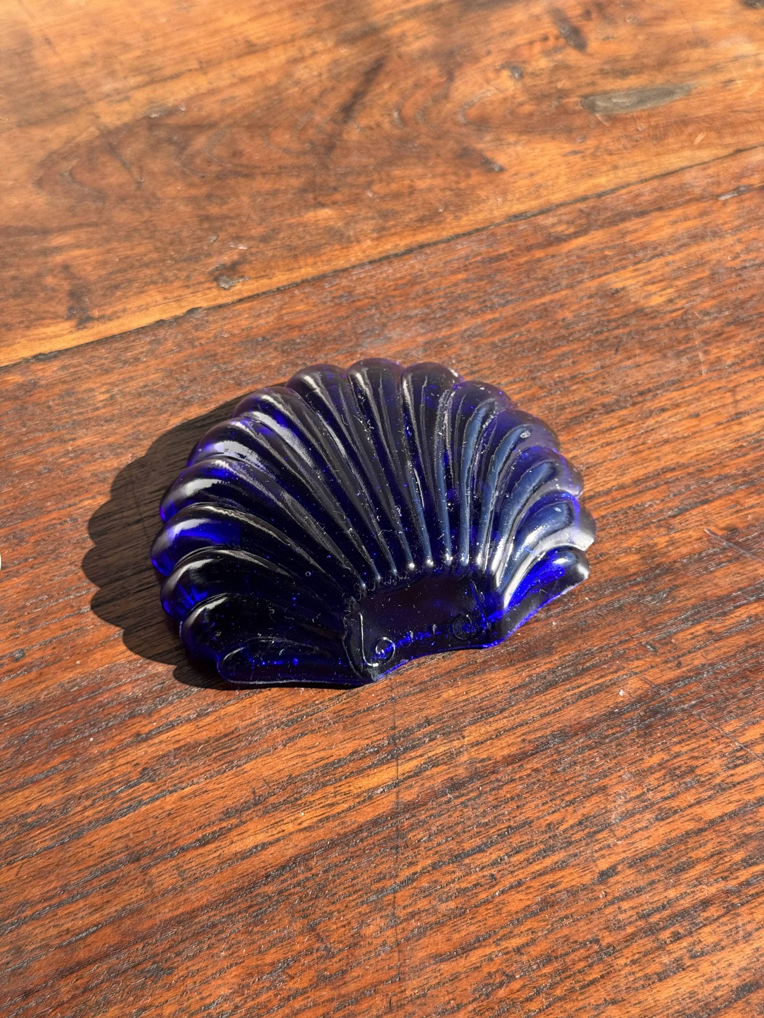 Vintage silver-plated shell butter dish with blue bowl.