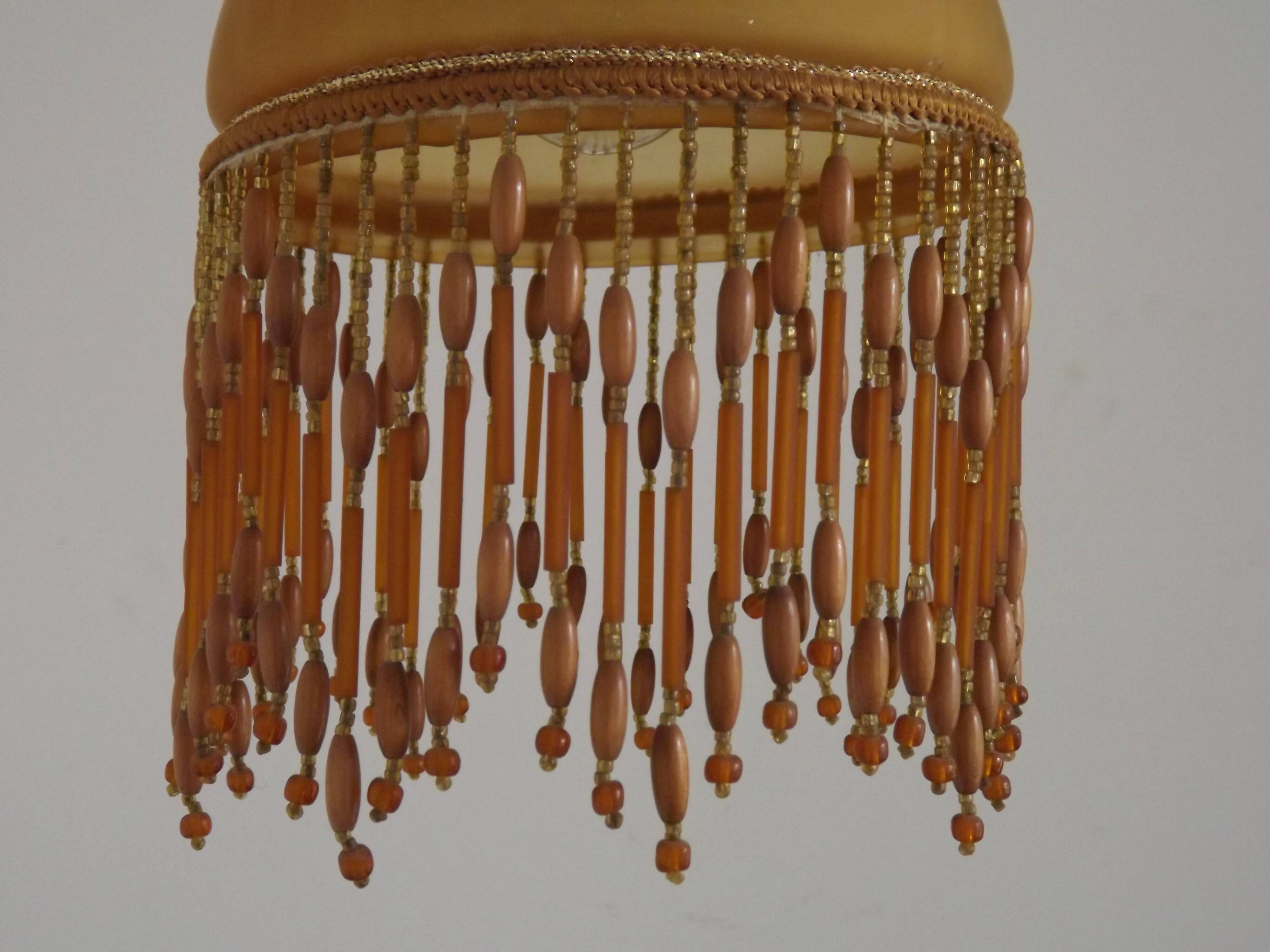 Vintage French amber mottled glass hanging ceiling light with beaded fringe.