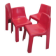 Four red fibreglass chairs from the 1970s.