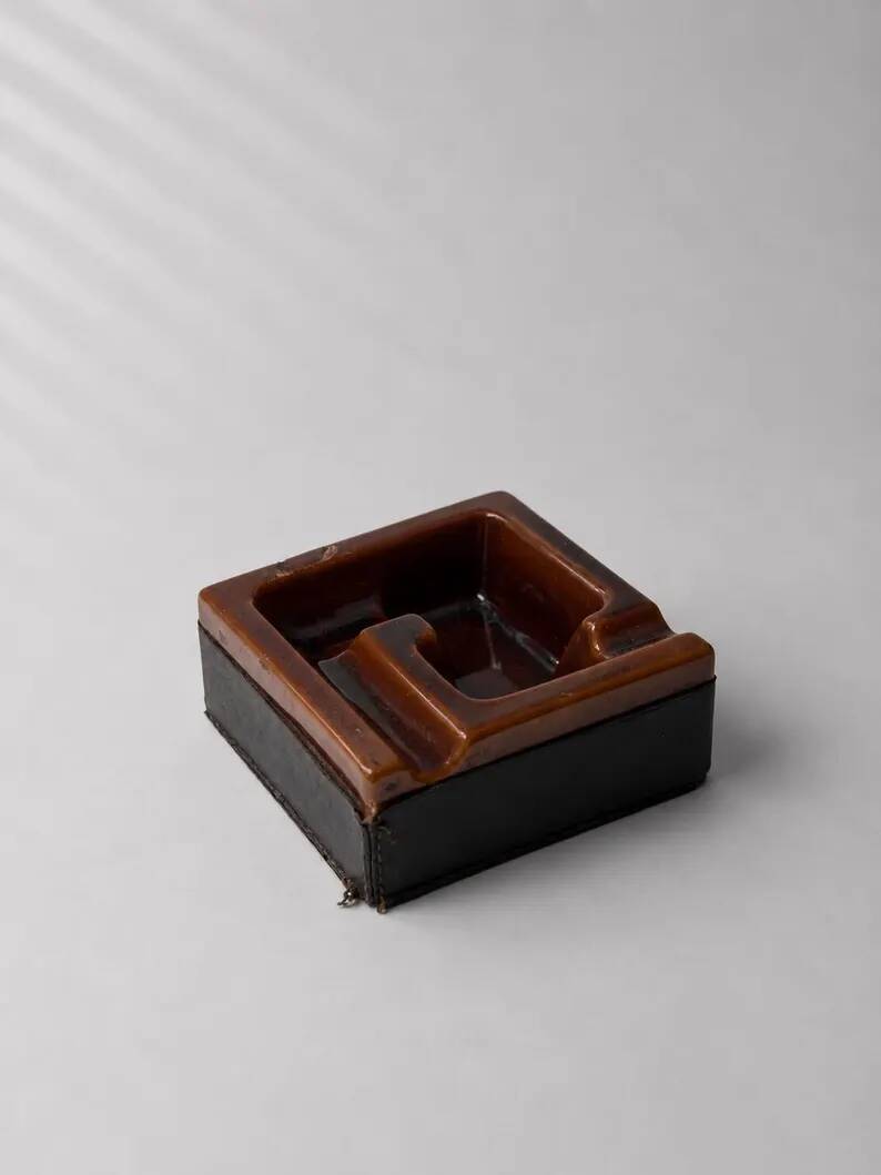 Geometric brown enamelled ashtray with a leather base (1960s-70s)