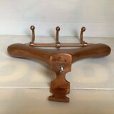 Wall mounted coat rack in the shape of a hanger