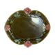 Old khaki green earthenware dish and pink flowers