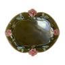 Old khaki green earthenware dish and pink flowers