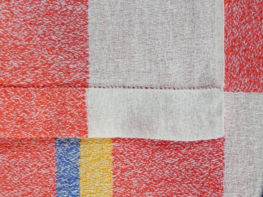 Old tablecloth and 11 towels crossed red blue