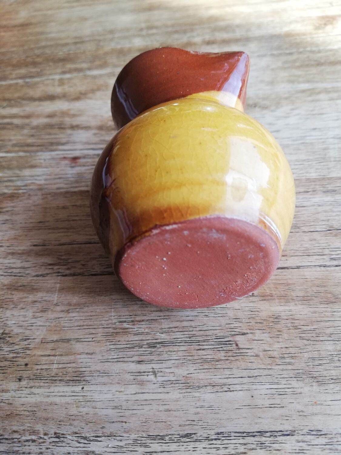 Small two-tone brown-yellow terracotta pitcher
