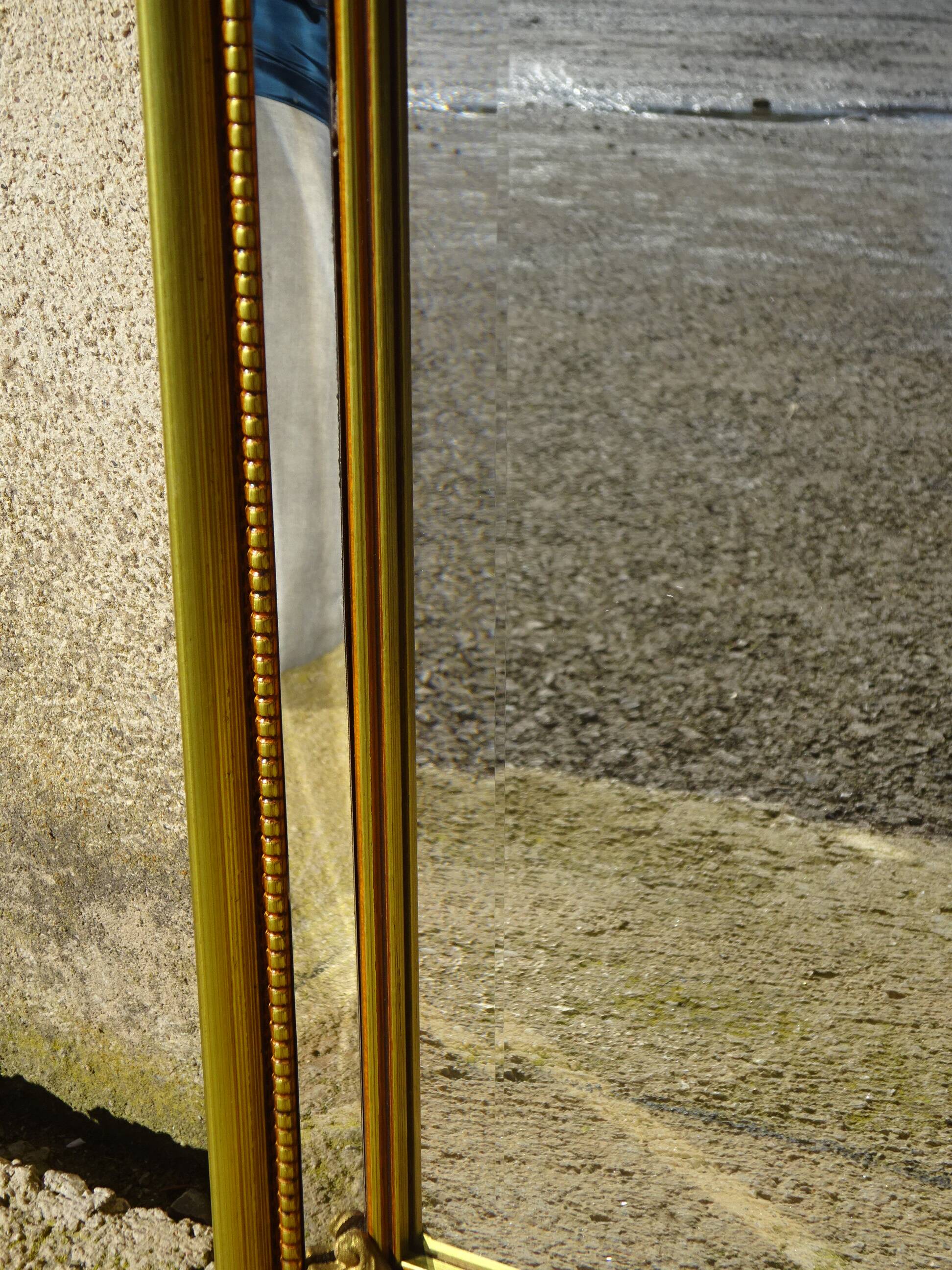Hall mirror, gilded frame with fillets and fleur-de-lis.