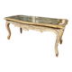 Louis XV style coffee table in carved wood with grey and gold highlights.