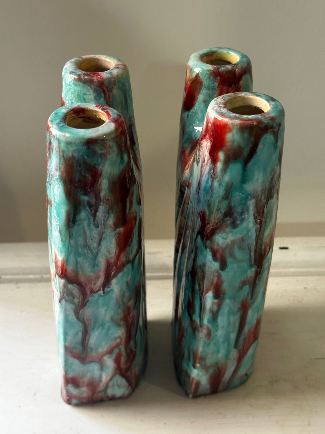 Vintage pair of turquoise and red ceramic candlesticks