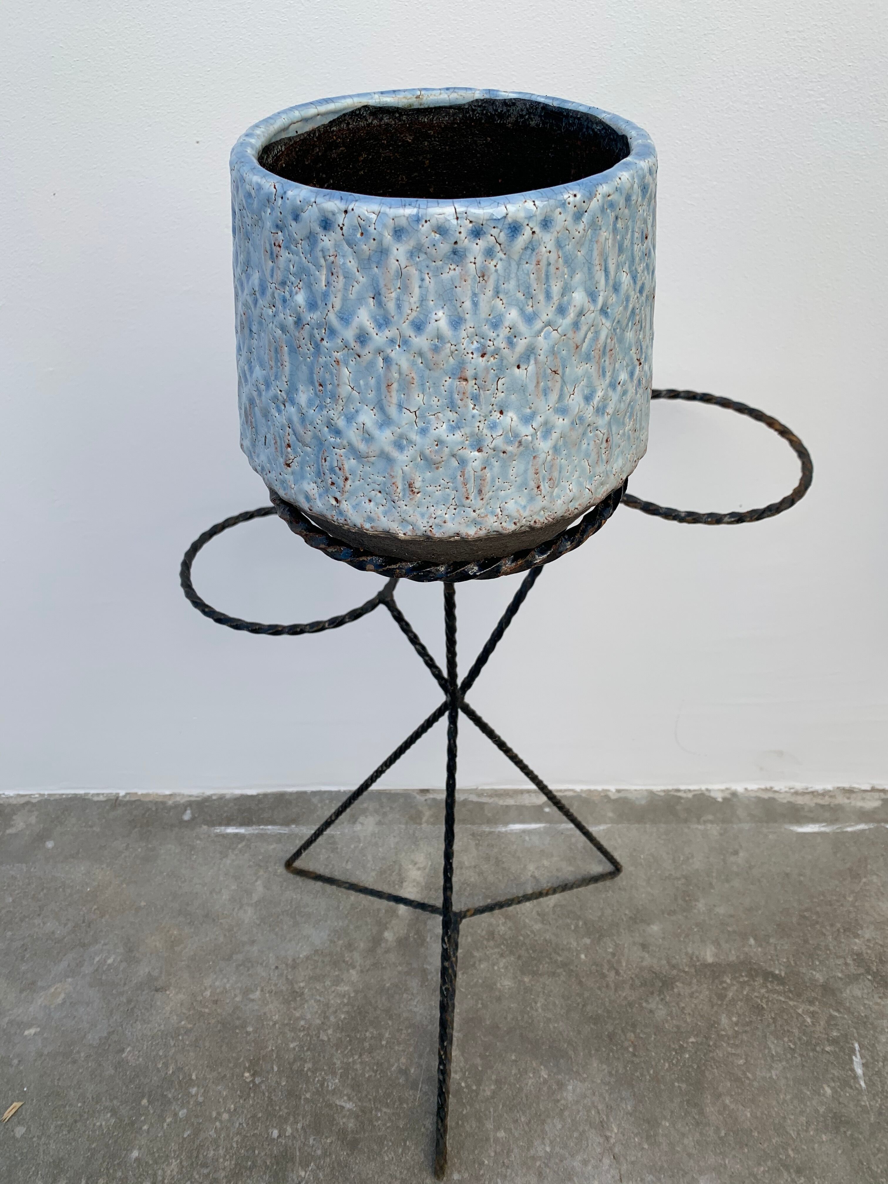 Black metal tripod plant holder