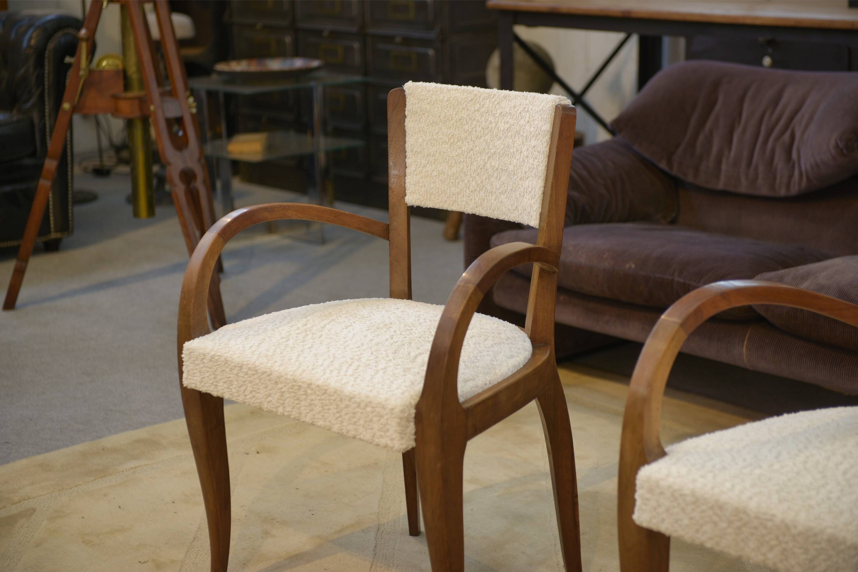 Pair of bridge armchairs in walnut and cream boucle fabric, early 20th century.