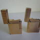 2 st dupont lighters, gold plated, punches, numbered, 1 striated pattern, 1 hammered pattern, 70s