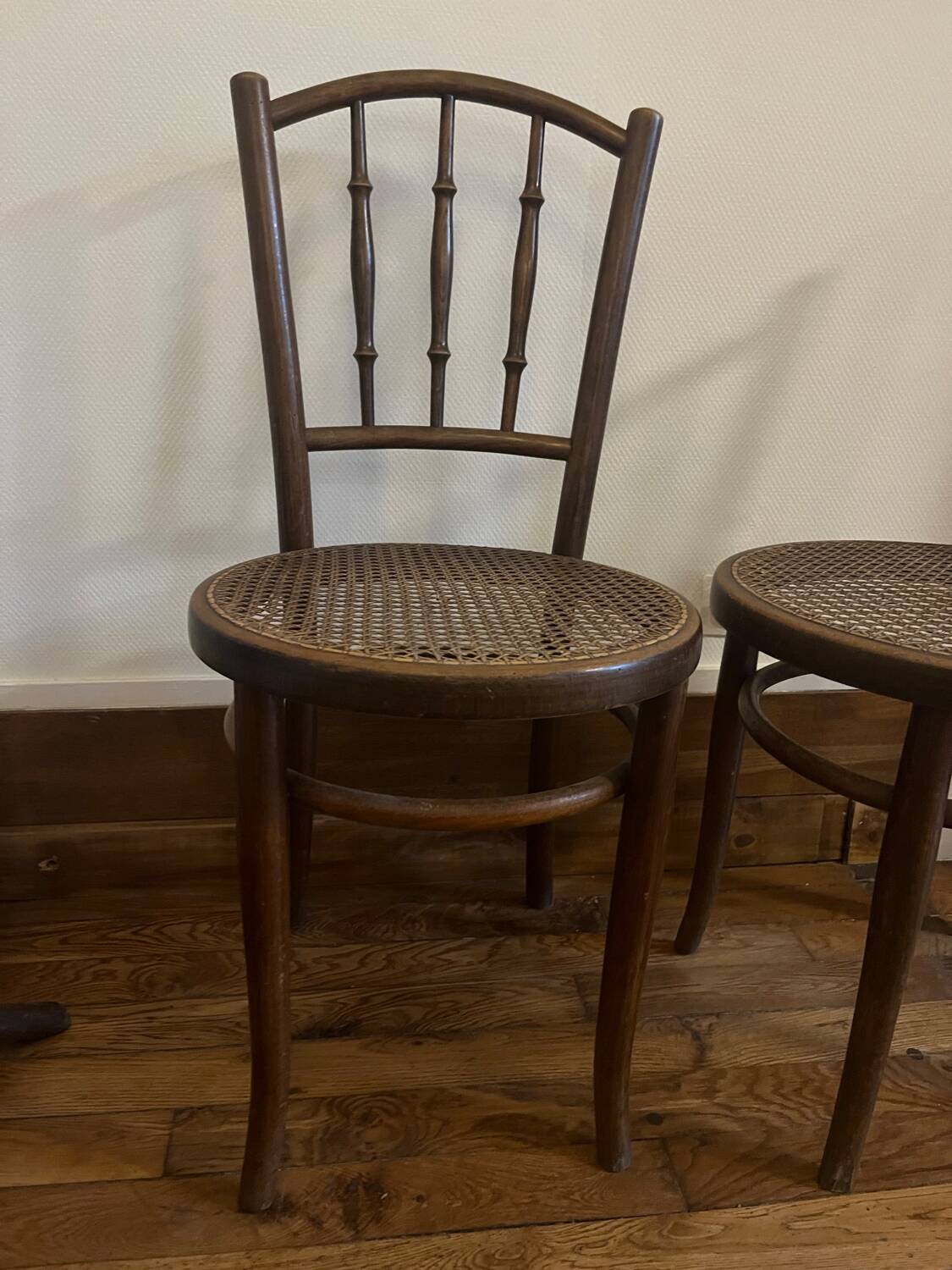 Pair of antique caned bistro chairs stamped Fischel