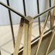 Neoclassical brass magazine rack attributed to Maison Ramsay.