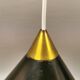 Cone pendant produced by Danish Lyfa in beautiful black lacquer with perforated shade and brass top.