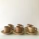 Stoneware coffee cups with saucers